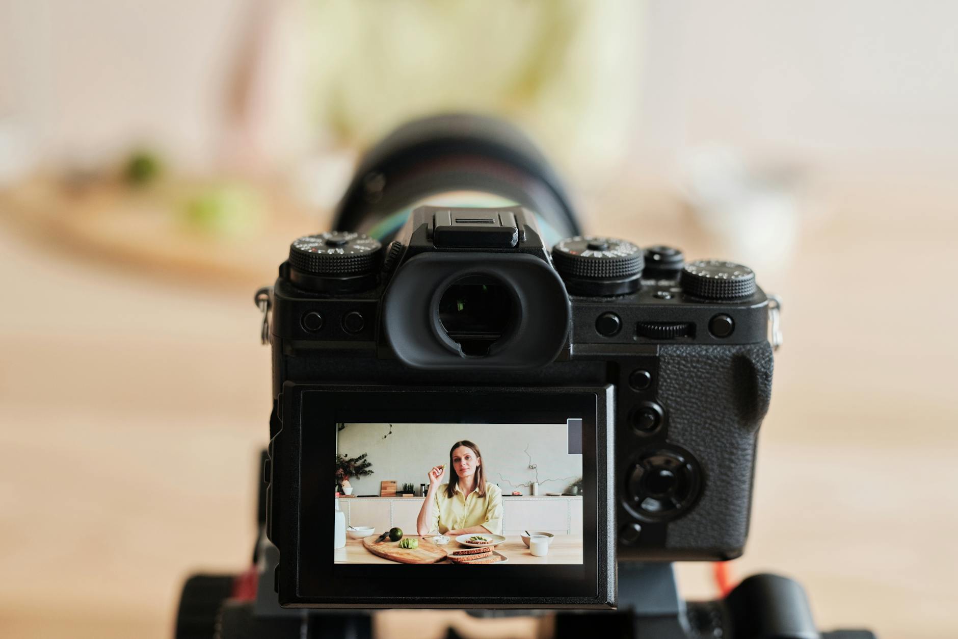 woman in yellow long sleeve shirt filming a vlog